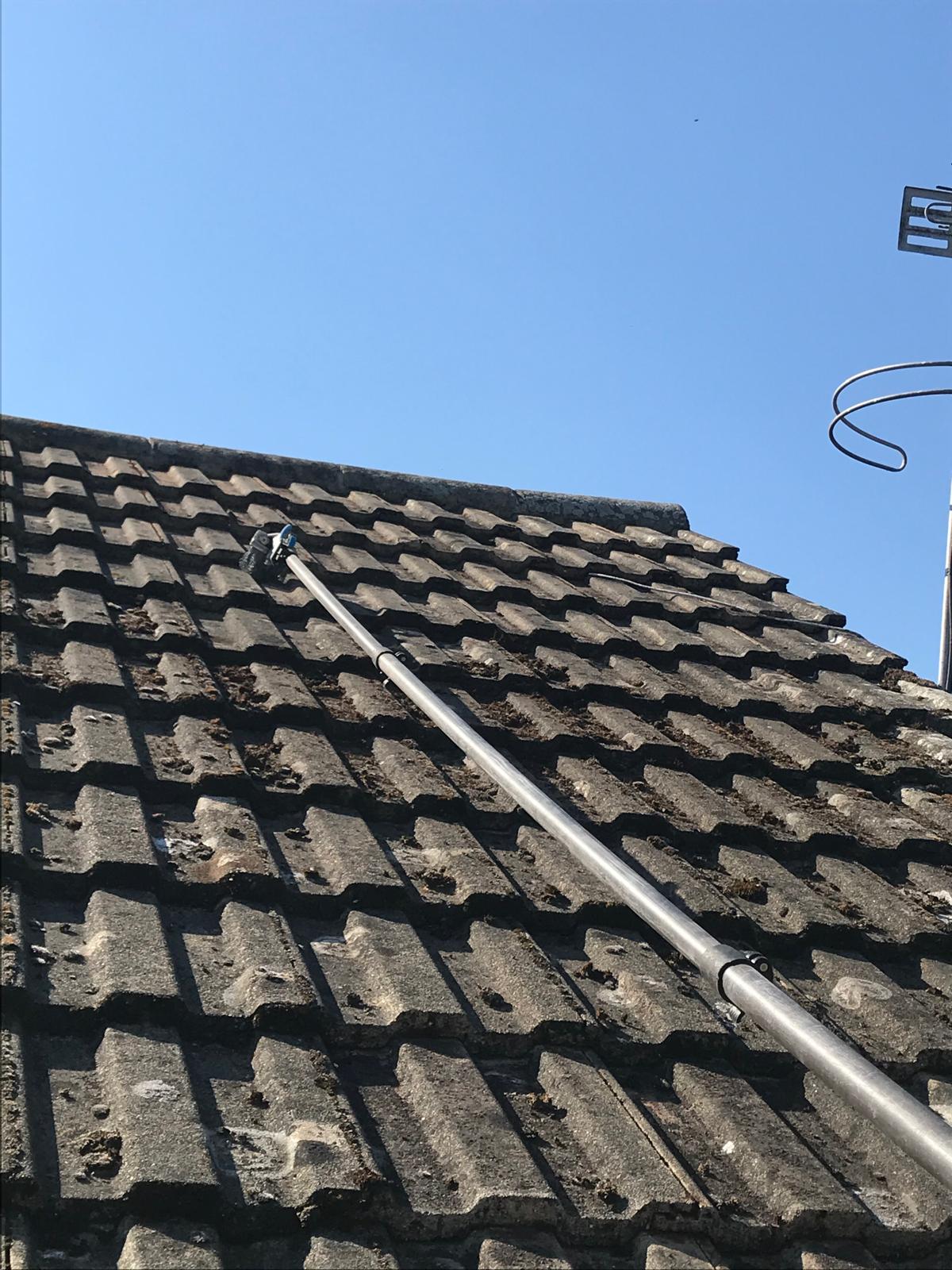 Manual moss removal from roof tiles by Noble Exterior Cleaning